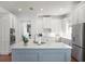 Bright kitchen features a central island, stainless steel appliances and abundant white cabinets at 4474 Enders St, Orlando, FL 32814
