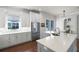 Modern kitchen with white cabinets, stainless steel appliances, and a large island with quartz countertops at 4474 Enders St, Orlando, FL 32814