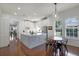 Bright kitchen featuring white cabinetry, stainless steel appliances, a large island, and a breakfast nook at 4474 Enders St, Orlando, FL 32814