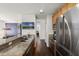 Kitchen featuring stainless steel appliances, granite countertops, and wood cabinets at 4474 Enders St, Orlando, FL 32814