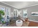 Cozy living room features neutral paint, wood floors, a comfortable sofa, and bright, shuttered windows at 4474 Enders St, Orlando, FL 32814