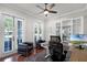 Bright home office with ample natural light, ceiling fan, and a modern desk setup at 4474 Enders St, Orlando, FL 32814