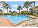 Resort-style pool featuring a central water feature, surrounded by palm trees and lounge seating at 4474 Enders St, Orlando, FL 32814
