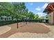 Charming swing set area surrounded by lush green trees, creating a serene place for to play at 4474 Enders St, Orlando, FL 32814