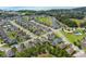 Aerial view showcasing a well-planned community with a lake, lush greenery, and neatly arranged homes at 459 Millwood Pl, Winter Garden, FL 34787