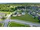 Aerial view of a community with lush landscaping, a pool, a park, and winding streets at 459 Millwood Pl, Winter Garden, FL 34787