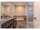 This well-lit bathroom features a double sink vanity, a tub and separate glass enclosed shower at 459 Millwood Pl, Winter Garden, FL 34787