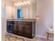 Bright bathroom with double sinks, dark wood cabinets and modern finishes and fixtures at 459 Millwood Pl, Winter Garden, FL 34787