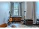 Comfortable bedroom features a window bench, musical instrument, and neutral-toned walls at 459 Millwood Pl, Winter Garden, FL 34787