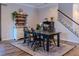 Dining area with wood-look flooring, decorative rug and hutch near staircase at 459 Millwood Pl, Winter Garden, FL 34787