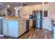 Kitchen with stainless steel refrigerator, white cabinets, and wood-look floors at 459 Millwood Pl, Winter Garden, FL 34787