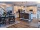 Open kitchen and dining area with wood-look flooring and white cabinets at 459 Millwood Pl, Winter Garden, FL 34787