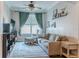 Bright living room featuring plush furniture, a ceiling fan, and tasteful decorations, creating a comfortable space at 459 Millwood Pl, Winter Garden, FL 34787