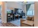 Relaxing living area boasting wood floors, modern entertainment center, and comfortable seating at 459 Millwood Pl, Winter Garden, FL 34787