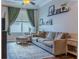 Cozy living room with large window, comfortable sofa, and stylish decor, perfect for relaxation at 459 Millwood Pl, Winter Garden, FL 34787