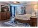 This cozy main bedroom features a ceiling fan, wood floors and a patterned rug at 459 Millwood Pl, Winter Garden, FL 34787