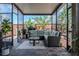 Enjoy this covered patio with pavers, string lights, brick surround, and a comfortable seating area at 459 Millwood Pl, Winter Garden, FL 34787