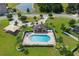 Aerial view of a community pool with lounge chairs and a covered pavilion in a well-maintained neighborhood at 459 Millwood Pl, Winter Garden, FL 34787