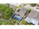 Aerial view of a home with an enclosed pool, solar panel, and a white fence at 491 Freeman St, Longwood, FL 32750