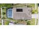 Aerial view of home featuring enclosed pool and solar panel with landscaping and green grass at 491 Freeman St, Longwood, FL 32750