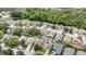 Aerial view of homes in a residential neighborhood surrounded by lush trees and a pond at 491 Freeman St, Longwood, FL 32750