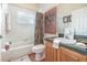 Bright bathroom with tile flooring, shower/tub combo, and shuttered window at 491 Freeman St, Longwood, FL 32750