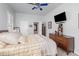 A traditionally furnished bedroom with a ceiling fan and a TV mounted on the wall at 491 Freeman St, Longwood, FL 32750