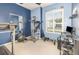 A well-equipped exercise room featuring a treadmill, weight machine, and natural light at 491 Freeman St, Longwood, FL 32750