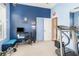 A functional exercise room with a treadmill, weights, and blue accent wall at 491 Freeman St, Longwood, FL 32750