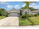 Charming single-story home with manicured lawn, lush landscaping, and a two-car garage at 491 Freeman St, Longwood, FL 32750