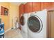 Laundry room featuring large washer and dryer, plenty of storage space with nice cabinets at 491 Freeman St, Longwood, FL 32750