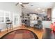 Spacious living room that includes ceiling fan, hard wood floors, vaulted ceilings and great view into kitchen at 491 Freeman St, Longwood, FL 32750