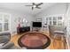 Bright living area featuring vaulted ceiling, ceiling fan, bar area, and large windows with plantation shutters at 491 Freeman St, Longwood, FL 32750
