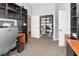 Office featuring carpet flooring, storage shelves, and view into hall at 491 Freeman St, Longwood, FL 32750