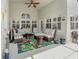 A cozy outdoor patio with comfortable seating and a colorful floral rug at 491 Freeman St, Longwood, FL 32750