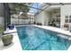 An inviting in-ground pool inside a screened enclosure, accompanied by lounge chairs and an outdoor seating area at 491 Freeman St, Longwood, FL 32750