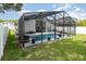 A screened backyard pool area showing the house and pool within a screened enclosure at 491 Freeman St, Longwood, FL 32750