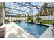 Enclosed pool area with beautiful blue tiled pool, outdoor seating, and white privacy fence at 491 Freeman St, Longwood, FL 32750
