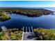Breathtaking aerial view of a vast lake featuring boat docks, bridges, lush forests, and scenic waterfront recreation at 550 Orient Ave, Debary, FL 32713