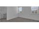 Bright bedroom with carpet, two windows, and an en-suite bathroom at 550 Orient Ave, Debary, FL 32713