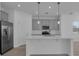 Modern kitchen with island, stainless steel appliances, and gray cabinetry at 550 Orient Ave, Debary, FL 32713