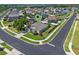 An aerial view of a single-Gathering home in a residential area, surrounded by other houses and lush trees at 570 Cascading Creek Ln, Winter Garden, FL 34787