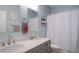 This bathroom features a double vanity and a shower with curtain at 570 Cascading Creek Ln, Winter Garden, FL 34787