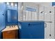 This bathroom features bold blue walls, white subway tile in the shower, and an updated vanity at 570 Cascading Creek Ln, Winter Garden, FL 34787