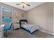 A bright bedroom has a blue bed and accents with natural light at 570 Cascading Creek Ln, Winter Garden, FL 34787