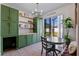 Open-concept dining area with a table, bench seating, built-in cabinets, and access to outdoor space at 570 Cascading Creek Ln, Winter Garden, FL 34787
