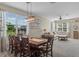 Charming dining area with a wooden table, stylish light fixture and natural light at 570 Cascading Creek Ln, Winter Garden, FL 34787