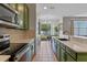 Well-lit kitchen with granite counters, modern appliances, an eat-in bar, and adjacent dining area at 570 Cascading Creek Ln, Winter Garden, FL 34787