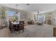 Bright, open-concept living and dining area with large windows and neutral decor at 570 Cascading Creek Ln, Winter Garden, FL 34787