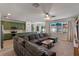 Stylish open-concept area with green cabinets, a sectional sofa, and natural light at 570 Cascading Creek Ln, Winter Garden, FL 34787